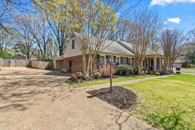 2060 Abergeldie Dr, Memphis, TN 38119 - view of front of property with covered porch, brick siding, fence, and a front lawn
