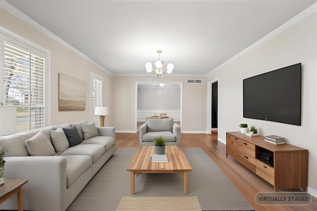 2060 Abergeldie Dr, Memphis, TN 38119 - living room featuring light wood-type flooring, an inviting chandelier, crown molding, and visible vents