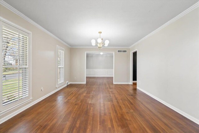 2060 Abergeldie Dr, Memphis, TN 38119 - empty room with crown molding, an inviting chandelier, baseboards, visible vents, and wood finished floors