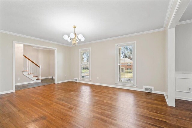 2060 Abergeldie Dr, Memphis, TN 38119 - unfurnished room featuring crown molding, stairway, a chandelier, visible vents, and wood finished floors