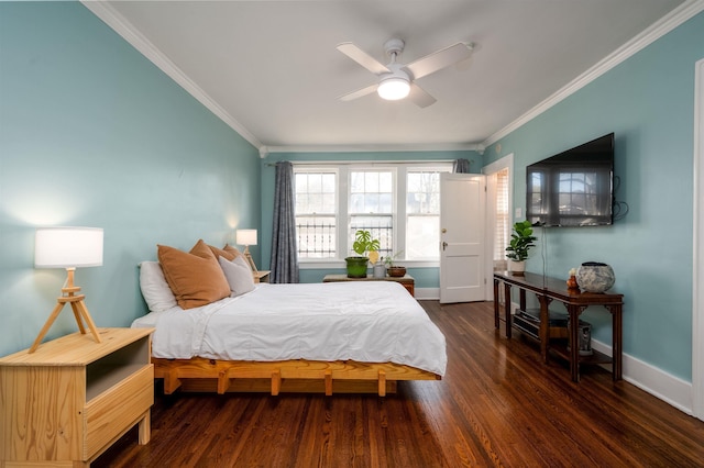 bedroom with baseboards, wood finished floors, ornamental molding, and a ceiling fan