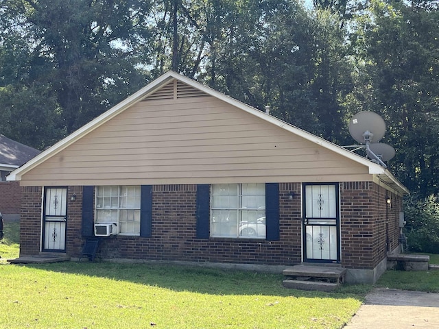 615 Mcwhirter Ave, Memphis, TN 38127 - view of front of property with cooling unit, brick siding, and a front yard