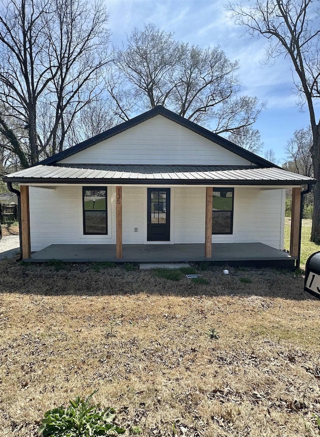 view of front of property with a standing seam roof, metal roof, and a porch