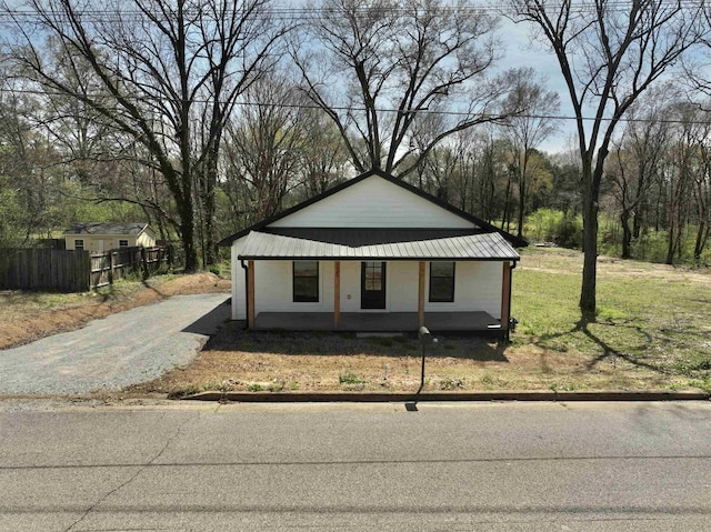 view of front of property with fence and metal roof