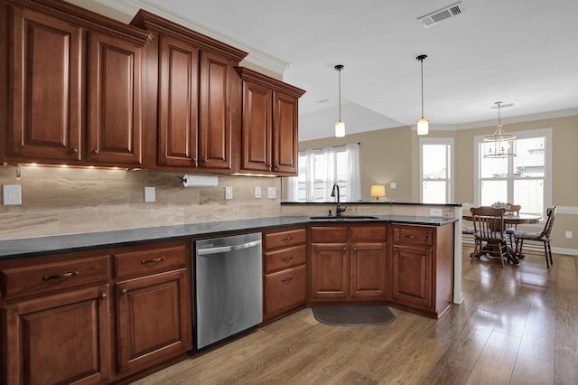 kitchen with a sink, dishwasher, light wood-type flooring, dark countertops, and visible vents