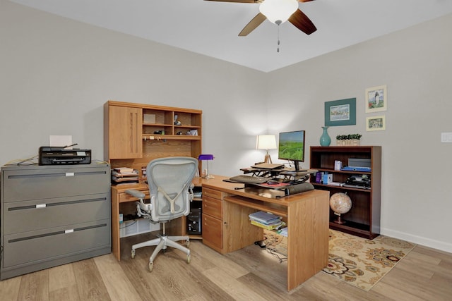 home office featuring baseboards, light wood-style floors, and a ceiling fan