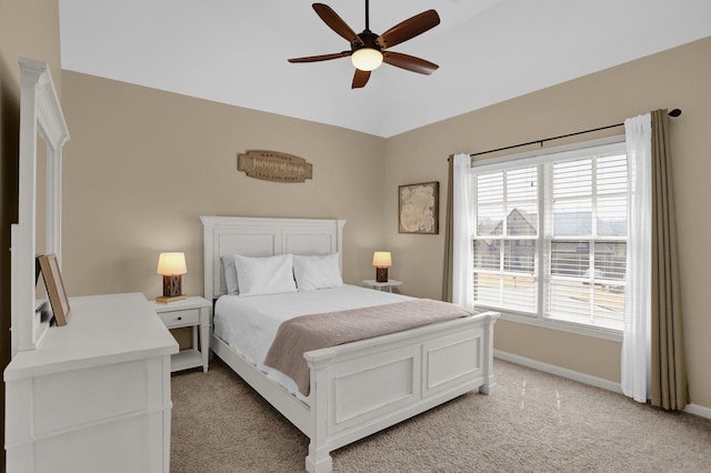 bedroom featuring baseboards, lofted ceiling, a ceiling fan, and light colored carpet