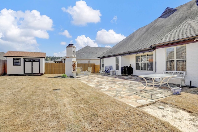 view of yard featuring a fenced backyard, an outbuilding, a patio, and a storage shed