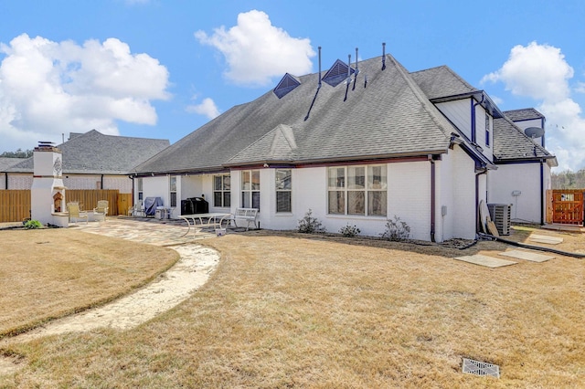 back of house featuring a patio, brick siding, fence, and cooling unit