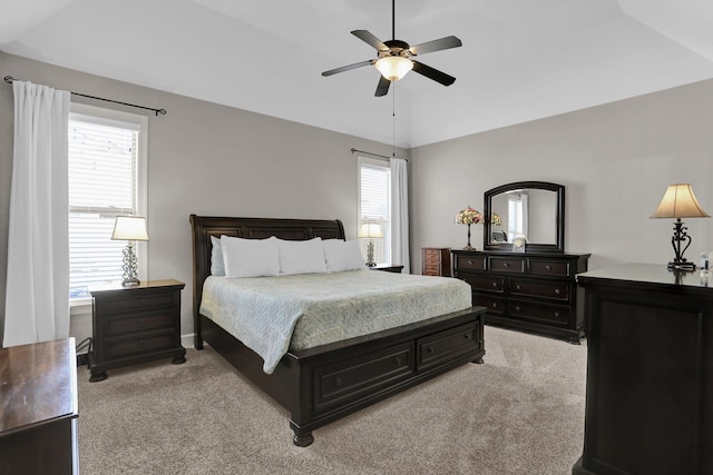 bedroom with light carpet, vaulted ceiling, and a ceiling fan