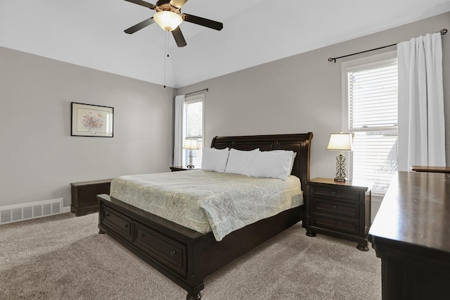 bedroom with lofted ceiling, visible vents, a ceiling fan, and light carpet