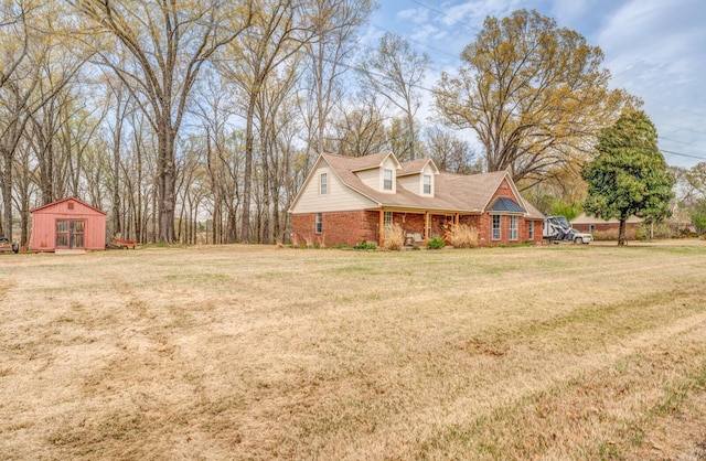 view of front of home with a front lawn and an outdoor structure