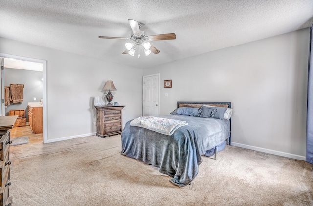bedroom with baseboards, a textured ceiling, and carpet