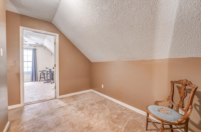 bonus room with vaulted ceiling, baseboards, light colored carpet, and a textured ceiling