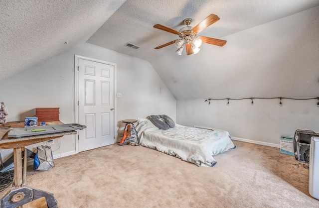 bedroom with carpet flooring, a textured ceiling, visible vents, and vaulted ceiling