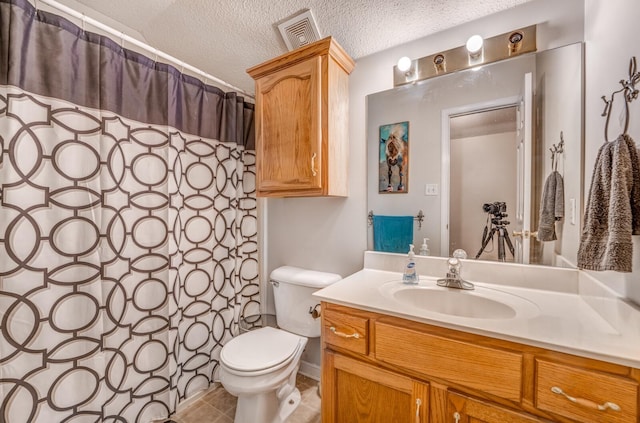 bathroom featuring vanity, toilet, a textured ceiling, visible vents, and curtained shower