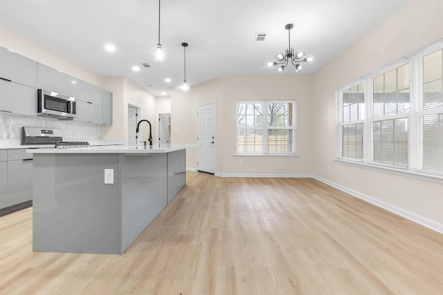 kitchen featuring modern cabinets, stainless steel appliances, and gray cabinets