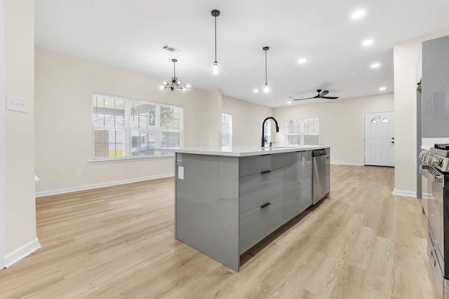 kitchen featuring stainless steel appliances, a sink, a wealth of natural light, visible vents, and modern cabinets