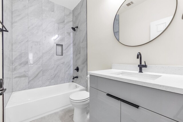 full bathroom featuring toilet, vanity, tub / shower combination, and visible vents