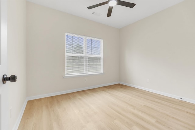 empty room with visible vents, baseboards, light wood-style floors, and ceiling fan