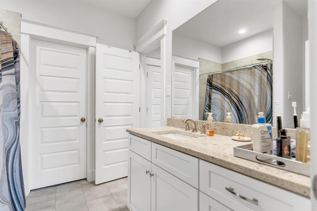 bathroom with a shower with curtain, tile patterned floors, and vanity