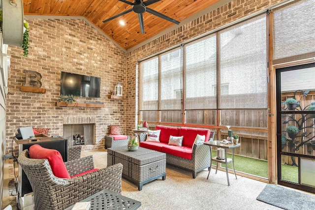 sunroom featuring ceiling fan and an outdoor living space with a fireplace