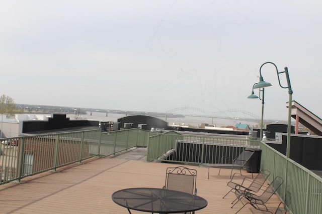 view of patio with a deck with water view