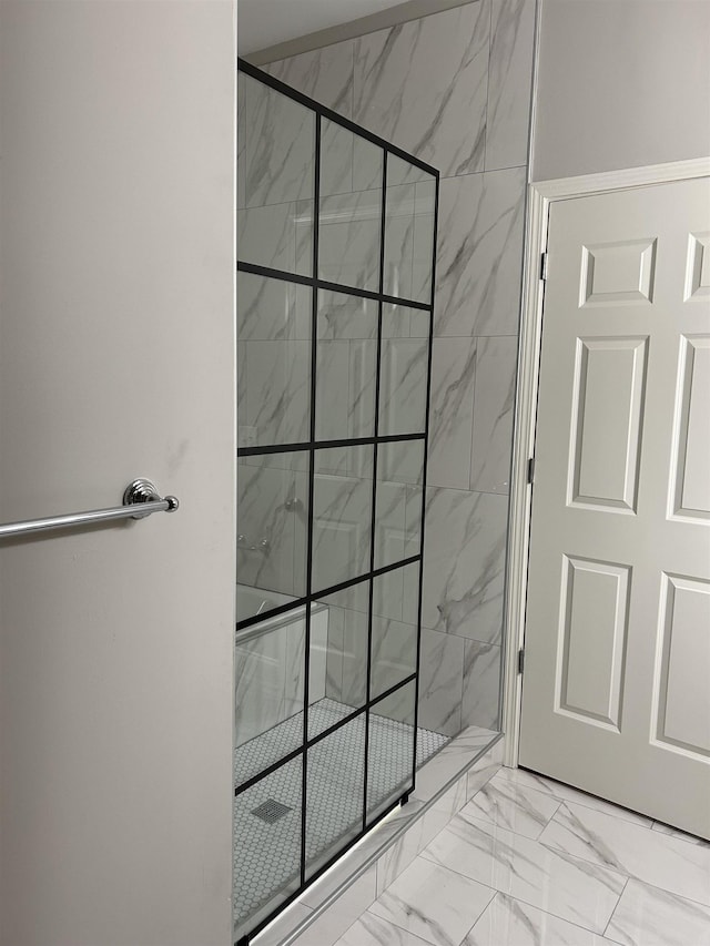 full bath featuring marble finish floor and a shower stall