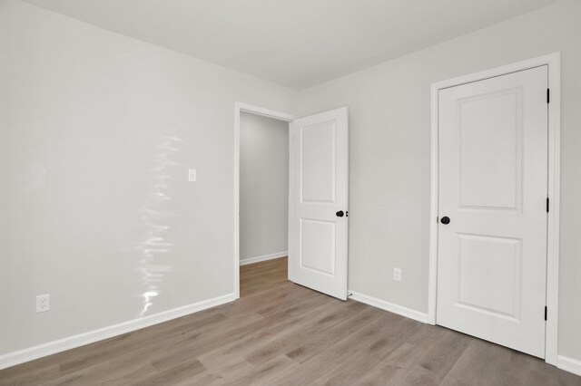 4443 Suncrest Dr, Memphis, TN 38127 - unfurnished bedroom featuring baseboards and wood finished floors