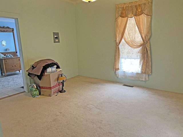 carpeted empty room with visible vents