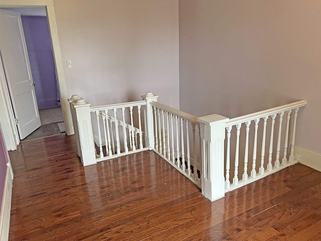 stairs featuring baseboards and wood finished floors