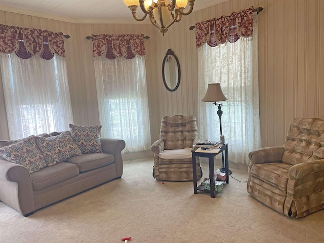 living room featuring a notable chandelier, crown molding, and carpet floors