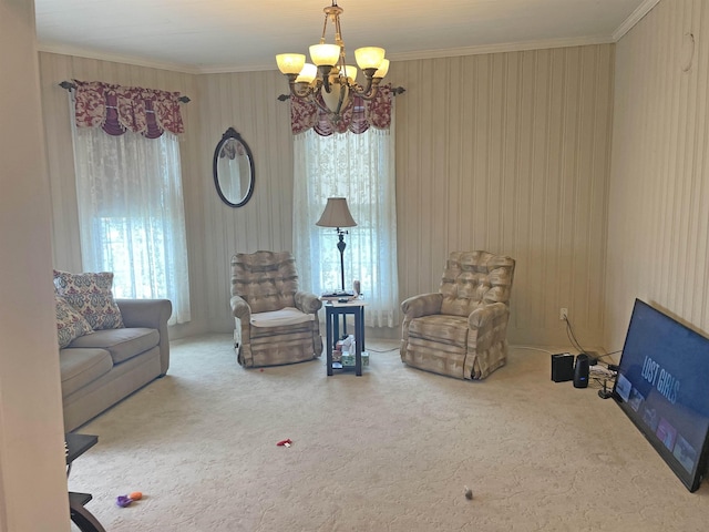 living area featuring a wealth of natural light, carpet, ornamental molding, and a chandelier