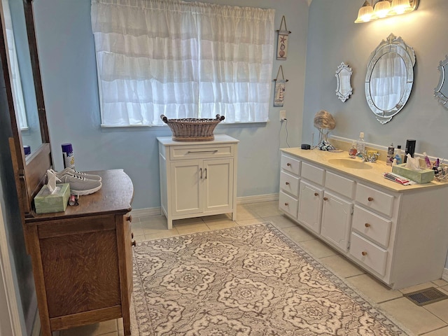 bathroom featuring baseboards, tile patterned floors, and vanity