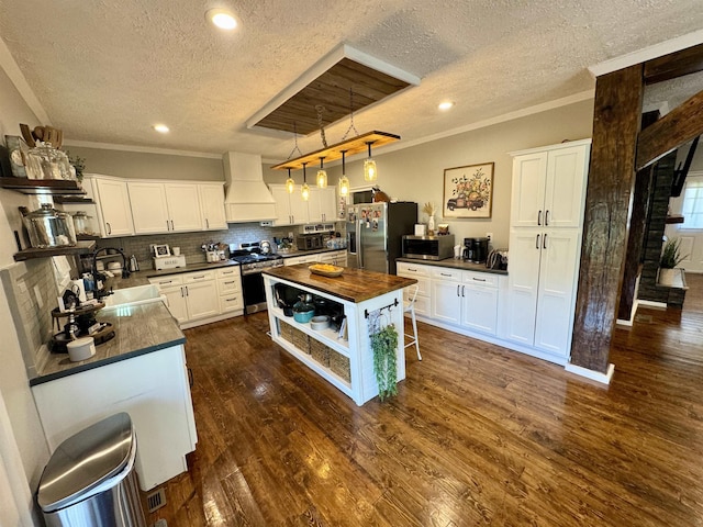 417 E Tigrett St, Halls, TN 38040 - kitchen featuring open shelves, appliances with stainless steel finishes, dark wood-style floors, butcher block counters, and custom range hood