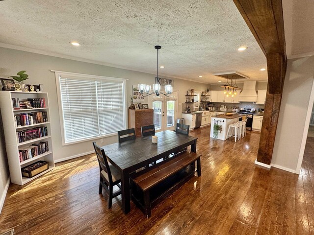417 E Tigrett St, Halls, TN 38040 - dining area featuring dark wood-style flooring, ornamental molding, and an inviting chandelier