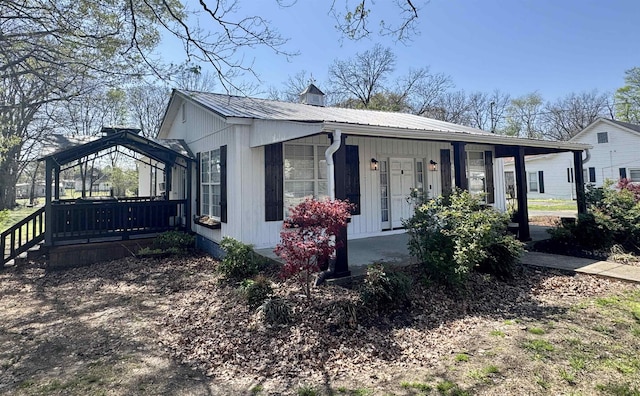417 E Tigrett St, Halls, TN 38040 - view of front facade featuring metal roof, a chimney, a gazebo, and a porch