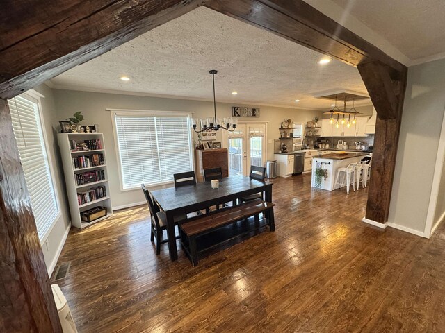 417 E Tigrett St, Halls, TN 38040 - dining area featuring baseboards, a textured ceiling, an inviting chandelier, and dark wood finished floors