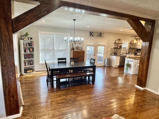 417 E Tigrett St, Halls, TN 38040 - dining space with an inviting chandelier, dark wood-type flooring, and a textured ceiling