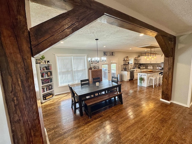 417 E Tigrett St, Halls, TN 38040 - dining room with dark wood-style flooring, a textured ceiling, and a notable chandelier