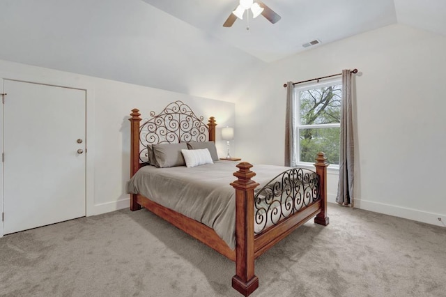 carpeted bedroom featuring a ceiling fan, baseboards, lofted ceiling, and visible vents