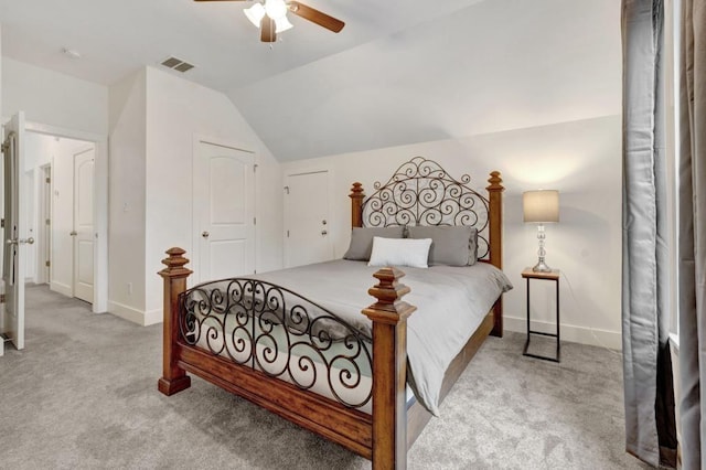 carpeted bedroom with a ceiling fan, baseboards, vaulted ceiling, and visible vents