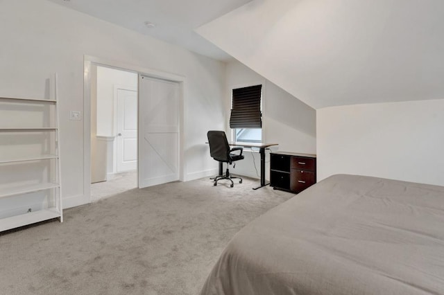 carpeted bedroom with baseboards and lofted ceiling