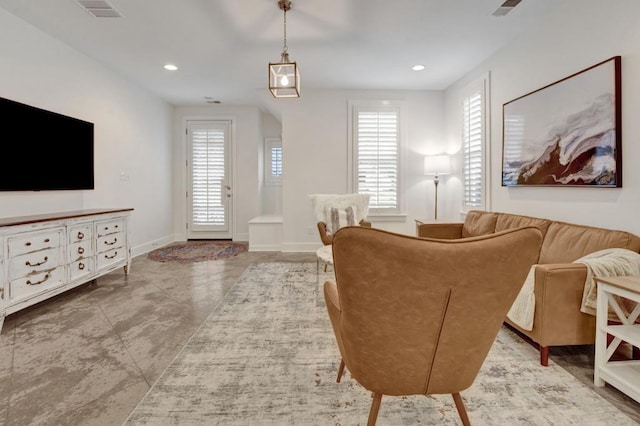 living area with baseboards, a wealth of natural light, visible vents, and recessed lighting
