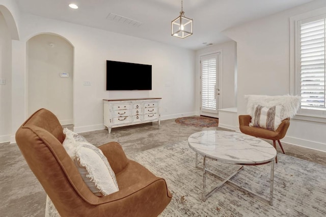 living room featuring baseboards, visible vents, recessed lighting, and plenty of natural light