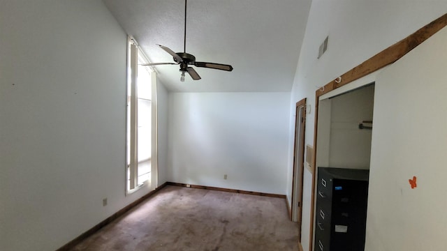 unfurnished bedroom featuring visible vents, baseboards, a ceiling fan, vaulted ceiling, and carpet flooring