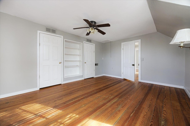 unfurnished bedroom with baseboards, visible vents, wood finished floors, and ceiling fan