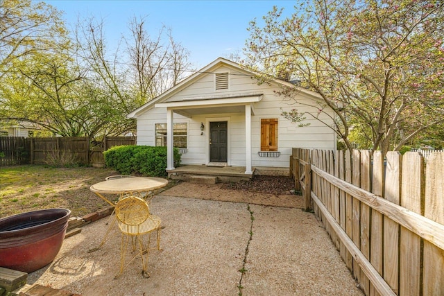 view of front of home featuring a fenced backyard and a patio