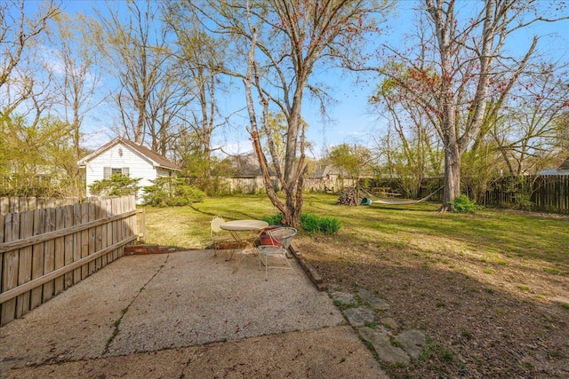 view of yard with a fenced backyard, a playground, and a patio area