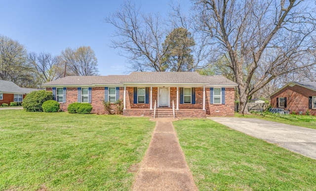 single story home featuring brick siding, a front yard, concrete driveway, and fence
